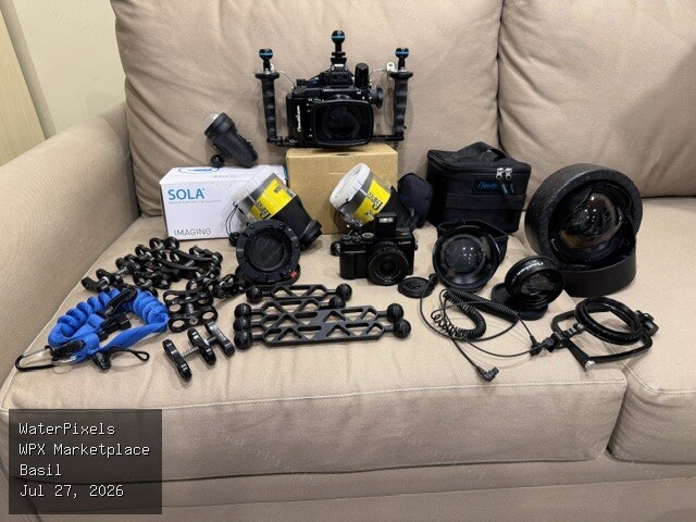 Panasonic LX100 II with Nauticam housing + N50 ports, Nauticam wide angle and macro wet lenses, dual Sea & Sea strobes, Sola video light, and accessories.